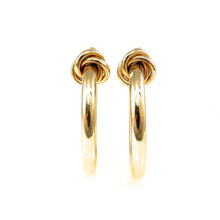 Load image into Gallery viewer, Pair of gold hoop earrings on a white background