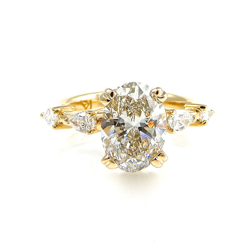 Oval Solitaire Engagement Ring with Pear Shaped Accents on yellow gold band