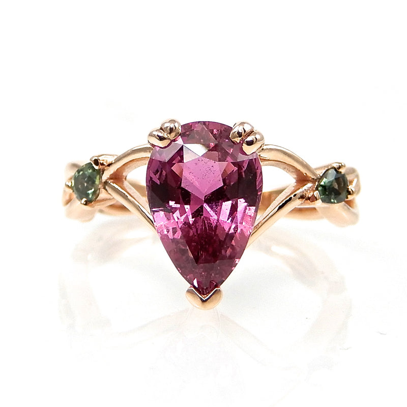 Pink Pear Shaped Sapphire Engagement Ring with green side stones set in rose gold
