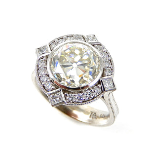 Round Bezel Set Diamond with Round and Princess Cut Halo Engagement Ring