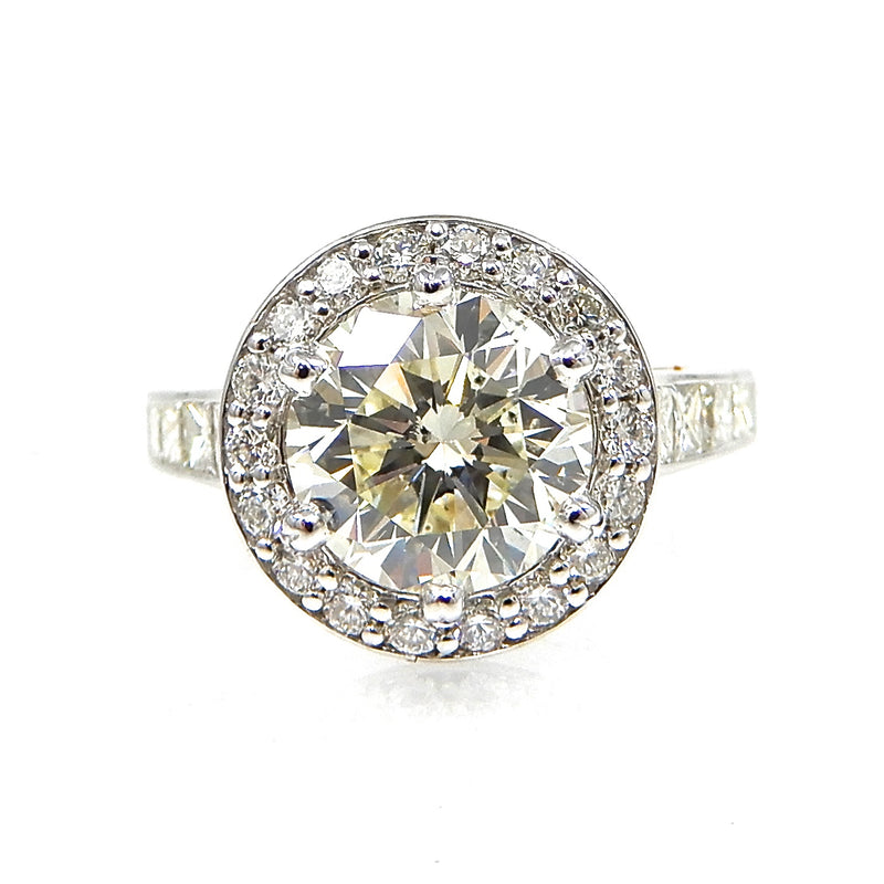 Round Cut Diamond with Diamond Halo and Princess Cut Accent Engagement Ring