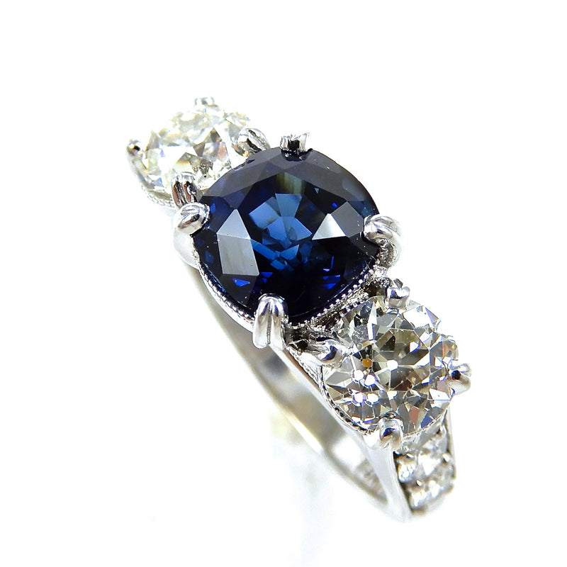 Round Sapphire Center Stone and Diamond Three Stone Engagement Ring