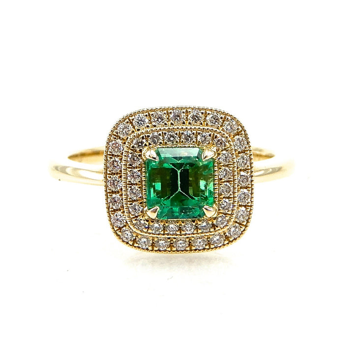 Square cut emerald with a double diamond halo with milgrain detail set in yellow gold