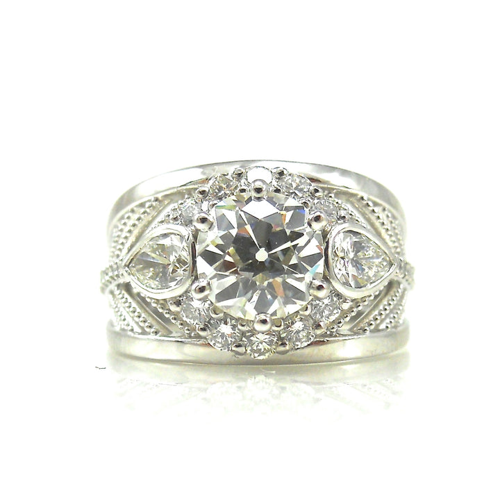 Old European cut diamond center stone with pear cut diamond accents