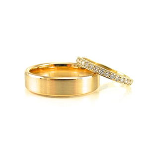 yellow gold wedding band for groom and matching yellow gold and diamond wedding band for her