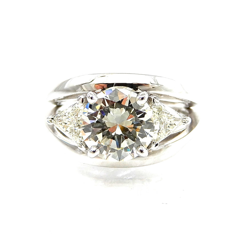 Custom ring round brilliant cut diamond center stone with trillion cut diamond accents