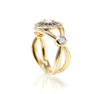 Handcrafted bezel set diamond engagement ring with double halo of sapphires and round brilliant diamonds