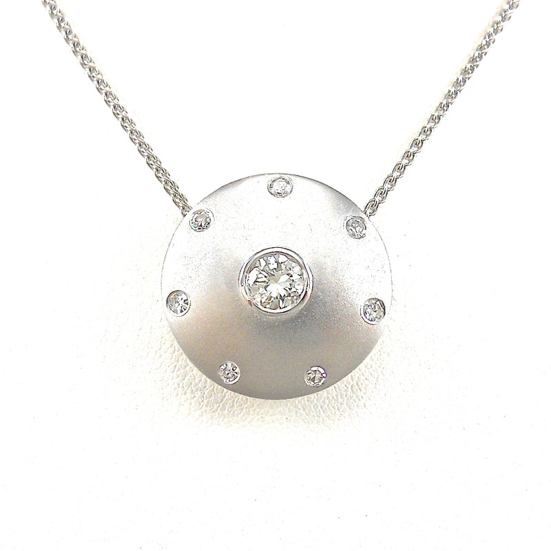 bezel-set round brilliant cut diamond center stone with diamond accents in satin finished white-gold necklace