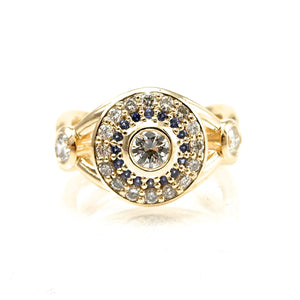 Bezel set diamond engagement ring with double halo of sapphires and round brilliant diamonds