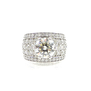 ound brilliant cut diamond center stone with a pave diamond accented shank and diamond borders