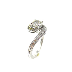 prong-set center stone and diamond accented bypass-style shank engagement ring