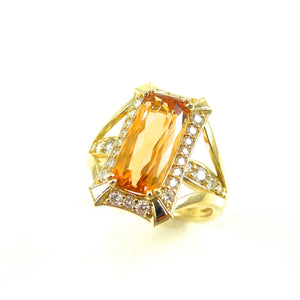 Imperial Topaz center stone ring with round brilliant cut diamond accents
