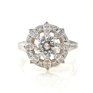 halo engagement ring with a star burst halo of diamonds surrounding the center stone