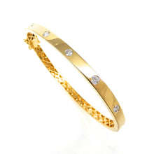 Load image into Gallery viewer, round diamonds flush set in a high shine yellow gold bangle 