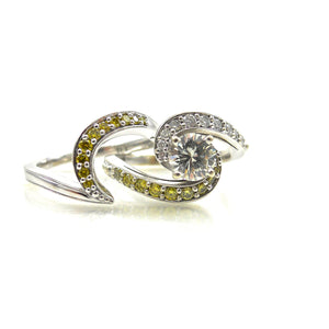 prong-set center stone and diamond accented bypass-style shank 